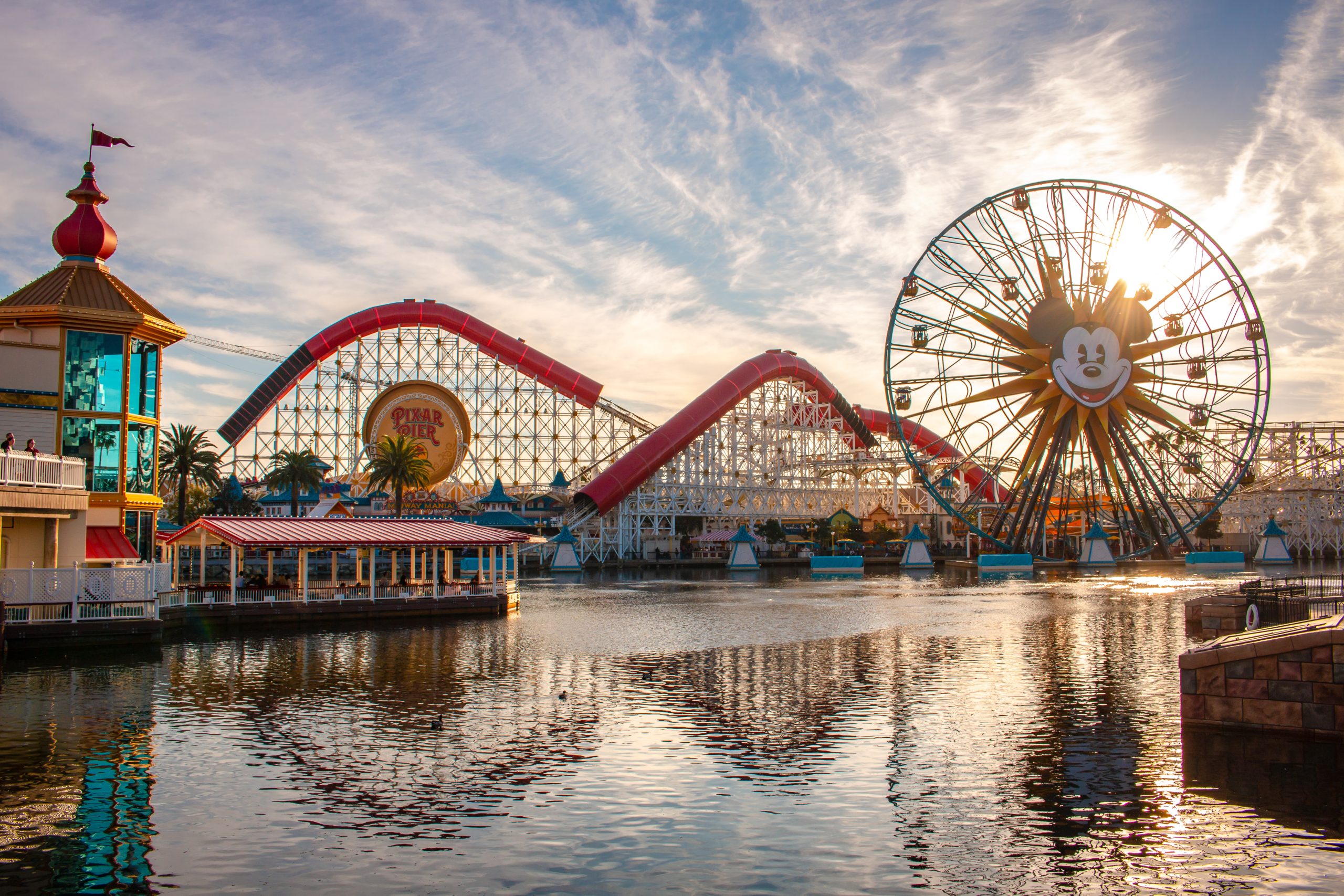 Pixar Pier at California Adventure, roller coaster and ferris wheel against sun