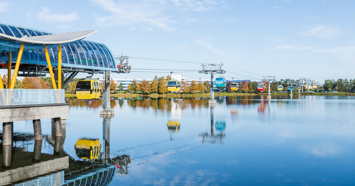 Disney Skyliner at Disney World, gondolas over water leaving station